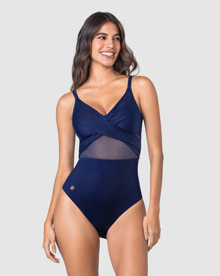 Bañador entero con escote cruzado y tela con brillo#color_509-azul-oscuro
